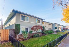 San Jose apartment for rent - A row of houses with a black fence in front.