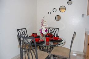 Modesto apartment for rent - a dining area with a round glass table and chairs