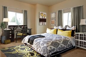 Lebanon apartment for rent - A bedroom with a large bed and a desk with a chair.