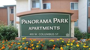 Bakersfield apartment for rent - a sign for panorama park apartments in front of flowers