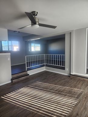 Winnetka apartment for rent - A room with a ceiling fan and wooden flooring.