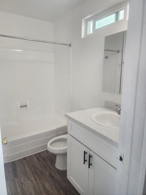 Winnetka apartment for rent - A white bathroom with a toilet, sink, and shower.