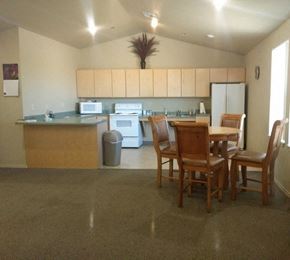 Taylor apartment for rent - a community room with a kitchen and dining area with a table and chairs