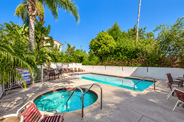 Reseda apartment for rent - A pool surrounded by chairs and trees.