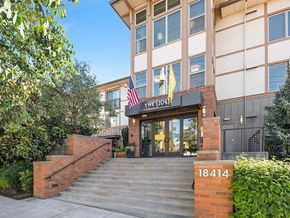 Bothell apartment for rent - The entrance to a building with a sign that reads "The 1041" and a flag on top.