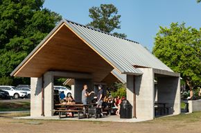 Kirkland apartment for rent - A group of people are sitting at a picnic table under a pavilion.