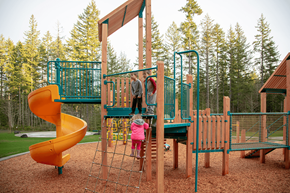 Port Orchard apartment for rent - A child playing on a playground with a yellow slide.