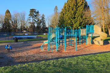 Kirkland apartment for rent - A playground with a blue slide and a yellow slide.