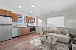 Port Orchard apartment for rent - A modern kitchen with wooden cabinets and stainless steel appliances.