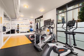 Bothell apartment for rent - a gym with treadmills and exercise equipment in a building with large windows