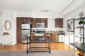 Bothell apartment for rent - a kitchen with stainless steel appliances and wooden cabinets