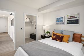 Seattle apartment for rent - a bedroom with a bed and a closet      and a hallway