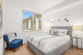 Bothell apartment for rent - a bedroom with a bed and a large window