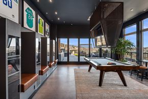 Seattle apartment for rent - a games room with a pool table and views of the city
