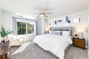 Duvall townhouse for rent - a bedroom with a large window and a ceiling fan