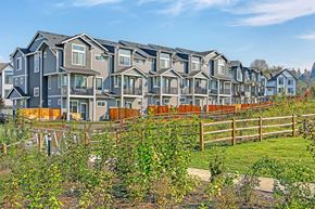 Duvall townhouse for rent - a row of houses on a hillside with a garden in front of them