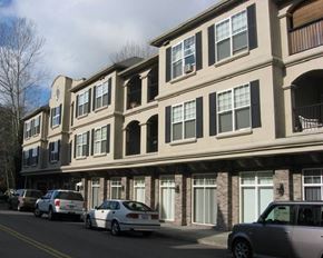 Kirkland apartment for rent - A row of townhouses with cars parked in front.