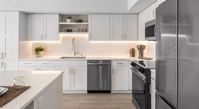 Redmond apartment for rent - A modern kitchen with white cabinets and stainless steel appliances.