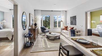 Redmond apartment for rent - A modern living room with a dining table set for two.