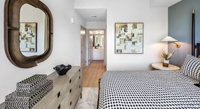Redmond apartment for rent - A bedroom with a large bed and a mirror on the wall.