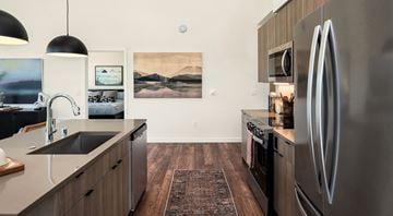 Woodinville apartment for rent - A modern kitchen with a stainless steel refrigerator and wooden cabinets.
