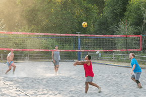 Kirkland apartment for rent - A group of people playing volleyball on a sandy court.