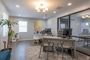 Nashville apartment for rent - A modern office space with a desk, chairs, and a computer.