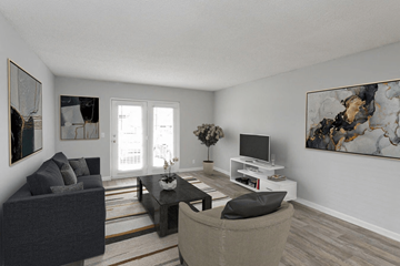 Nashville apartment for rent - A living room with a grey couch, a black chair, a coffee table, a television, and two paintings on the wall.