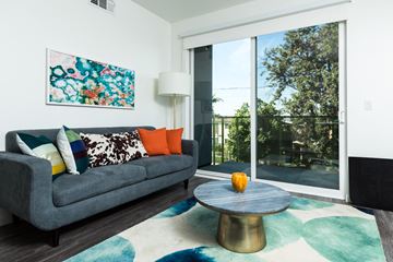 Los Angeles apartment for rent - a living room with a gray couch and a coffee table