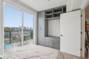 Los Angeles apartment for rent - A bedroom with a large bed and a balcony overlooking a cityscape.