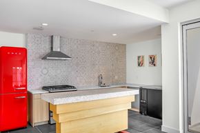 Los Angeles apartment for rent - a kitchen with a large island and a red fridge