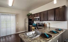 Wichita apartment for rent - a kitchen with stainless steel appliances and a granite counter top