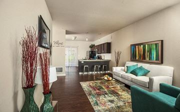 Wichita apartment for rent - a living room with a couch and a chair and a kitchen