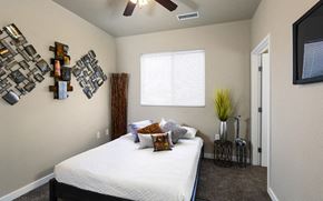 Wichita apartment for rent - a bedroom with a bed and a ceiling fan