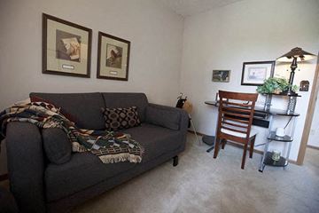 Wichita apartment for rent - a living room with a couch and a chair