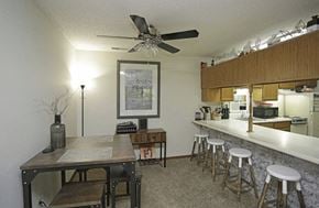Wichita apartment for rent - an open kitchen and dining room with a long counter and a bar with stools