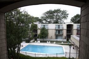 Wichita apartment for rent - the view of a swimming pool in front of an apartment building