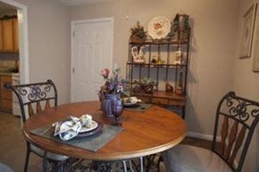 Wichita apartment for rent - a dining room with a wooden table and chairs