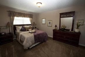Wichita apartment for rent - a bedroom with a bed and a dresser