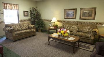 Wichita apartment for rent - a living room with couches and a table with flowers
