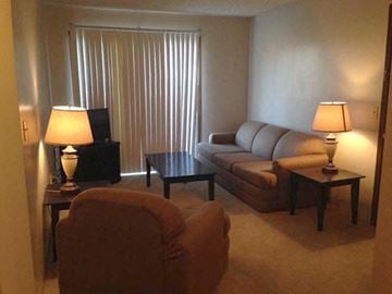 Wichita apartment for rent - a living room with a couch and a chair