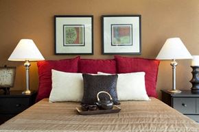 Wichita apartment for rent - a bedroom with a bed with three pictures on the wall