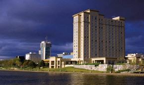 Wichita apartment for rent - a tall building sitting next to a body of water
