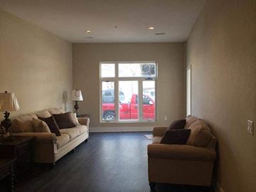 Wichita apartment for rent - a living room with two couches and a window