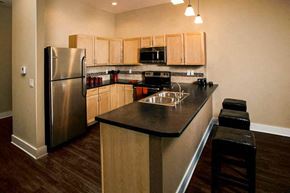 Wichita apartment for rent - a kitchen with a stainless steel refrigerator and a counter top