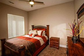 Wichita apartment for rent - a bedroom with a bed and a ceiling fan