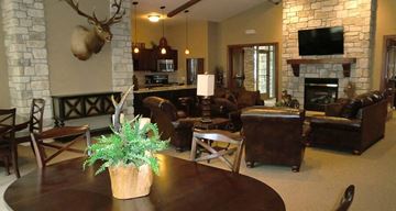 Wichita apartment for rent - a living room with couches a table and a fireplace