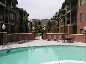 Wichita apartment for rent - a swimming pool in front of an apartment building