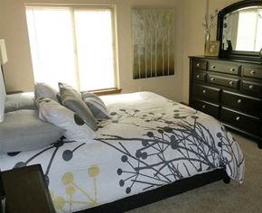 Wichita apartment for rent - a bedroom with a bed and a dresser
