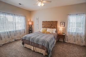 Wichita apartment for rent - a bedroom with a bed and a ceiling fan